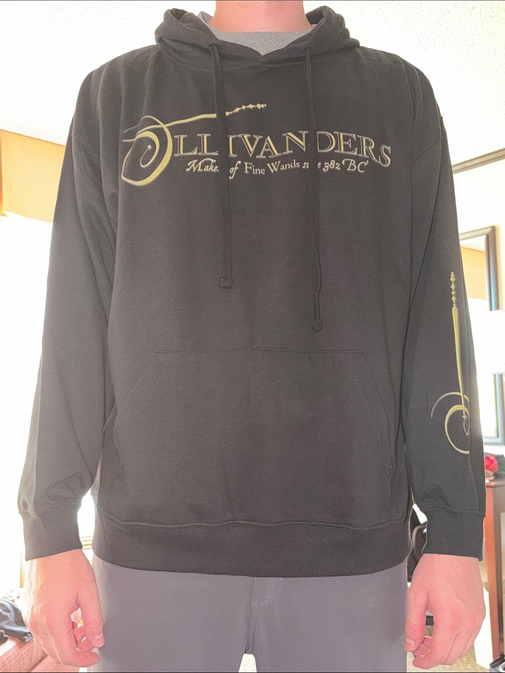 Ollivanders Black Hoodie with Gold Wand Graphic